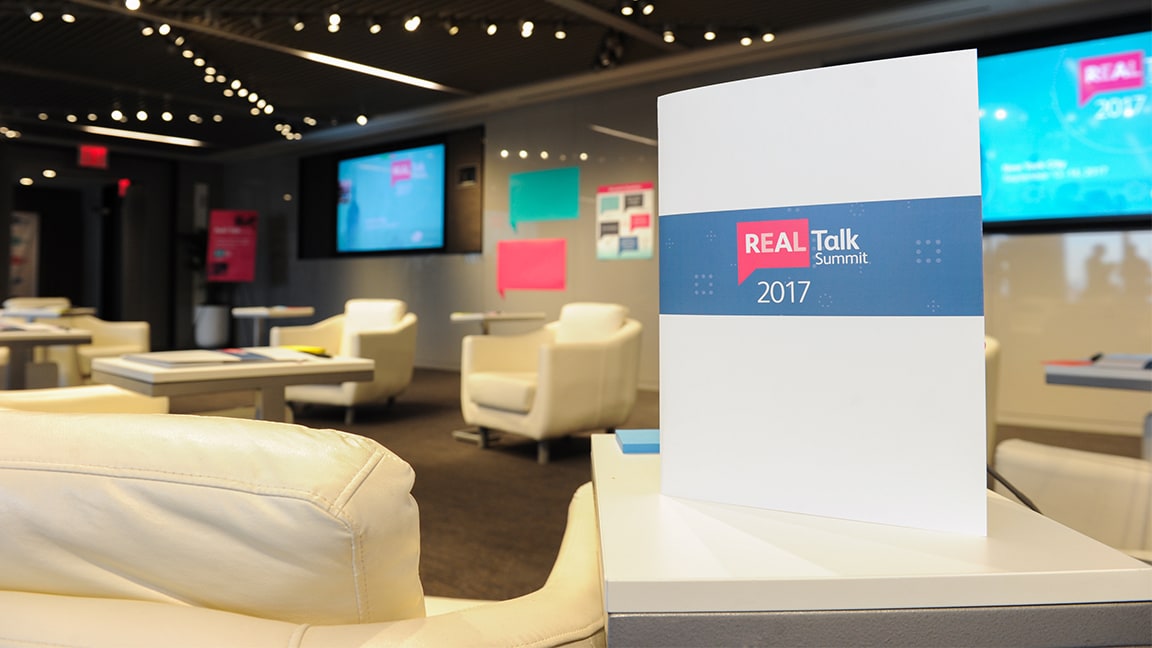 Photo of Real Talk Summit brochure on table