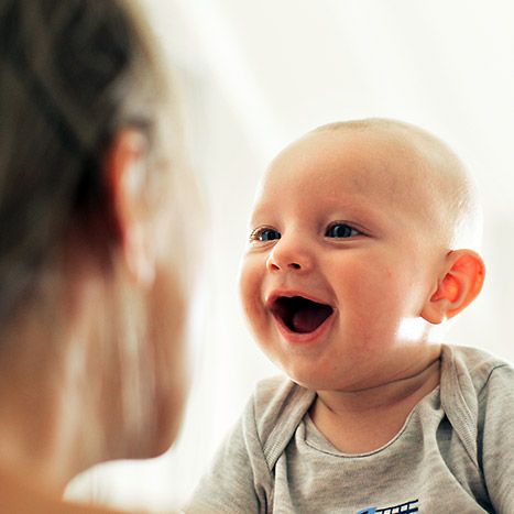 Baby smiling at mother