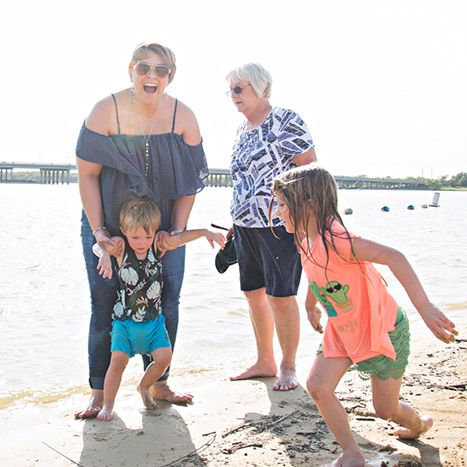 Two ladies on beach with two children