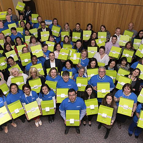 Pfizer employees holding boxes