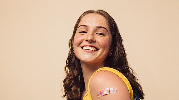 Adolescent with bandaid after getting vaccine
