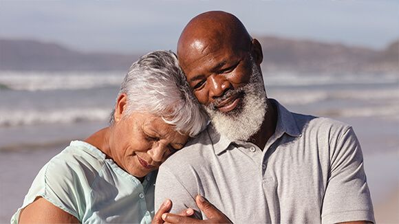 Two older adults hugging
