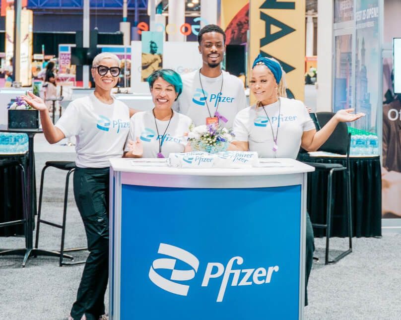 Pfizer brand ambassadors at Essence Fest booth