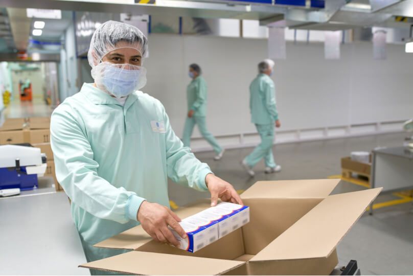 A worker packs PAXLOVID to be distributed