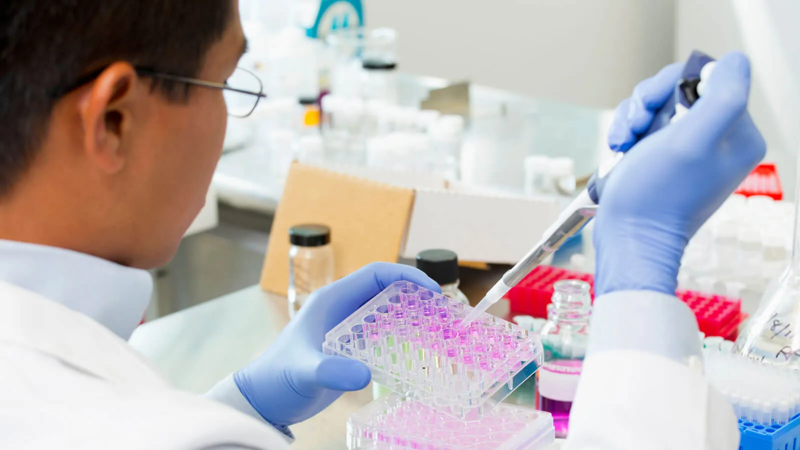 Scientist filling vials for testing