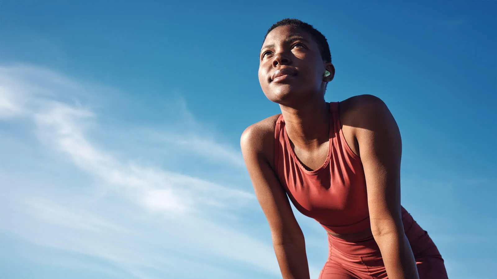 Black woman, exercise or tired after training, running or workout for balance, wellness or health outdoor.