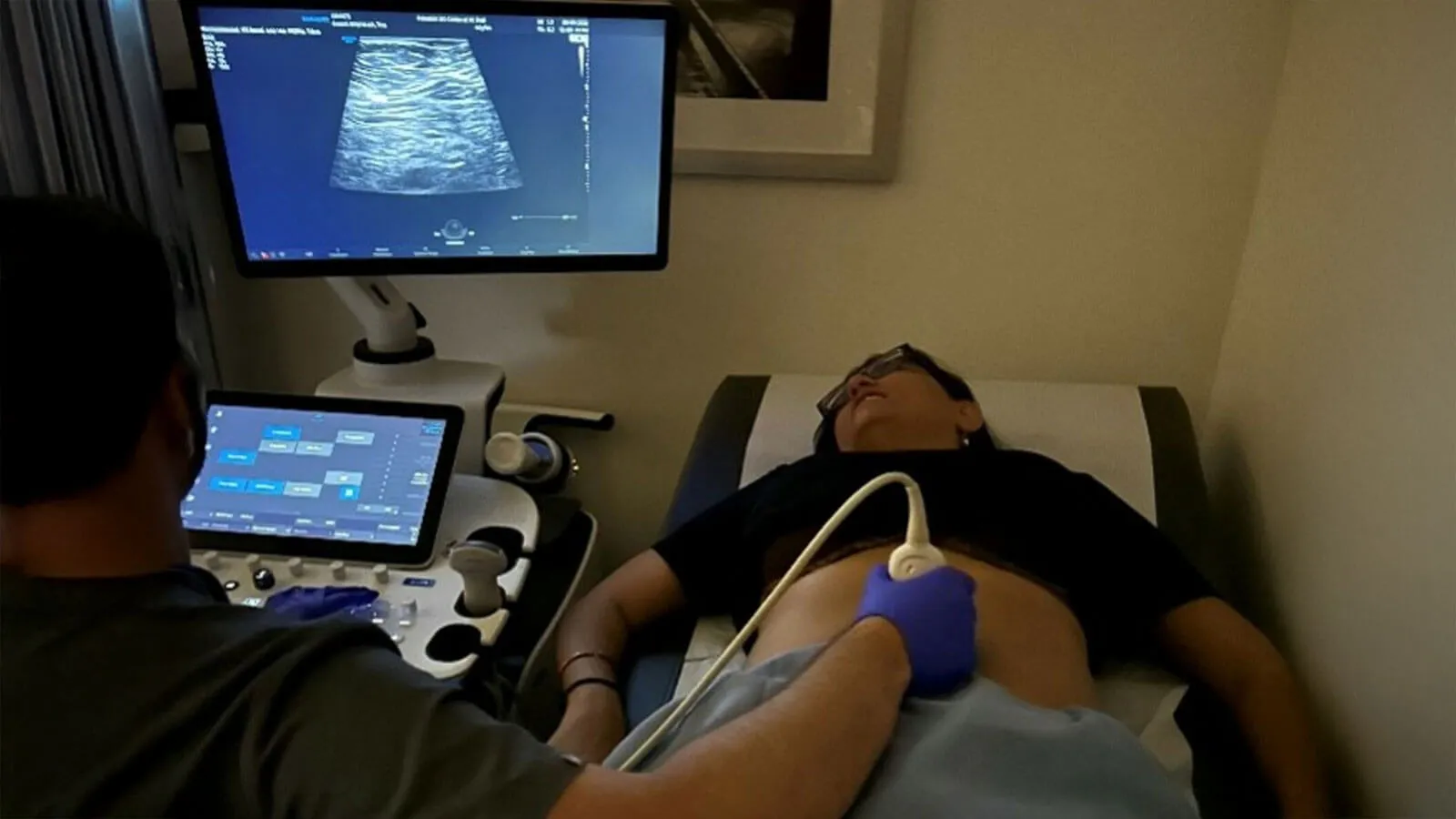 Technician performing sonogram